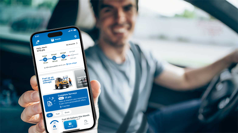 Man holding phone showing chevron texaco rewards mobile app